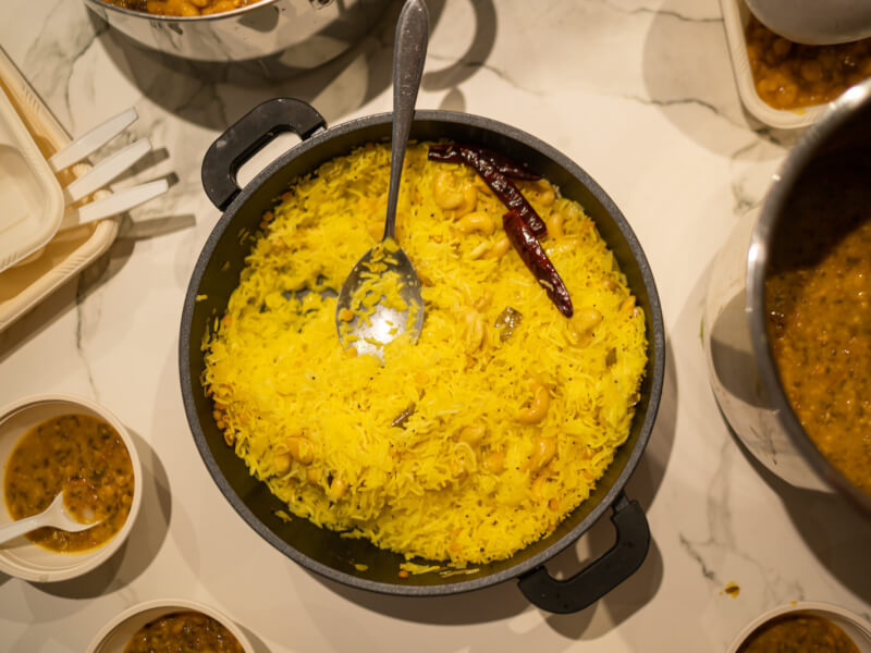 A bowl of yellow rice on a dining table made in a cooking course.
